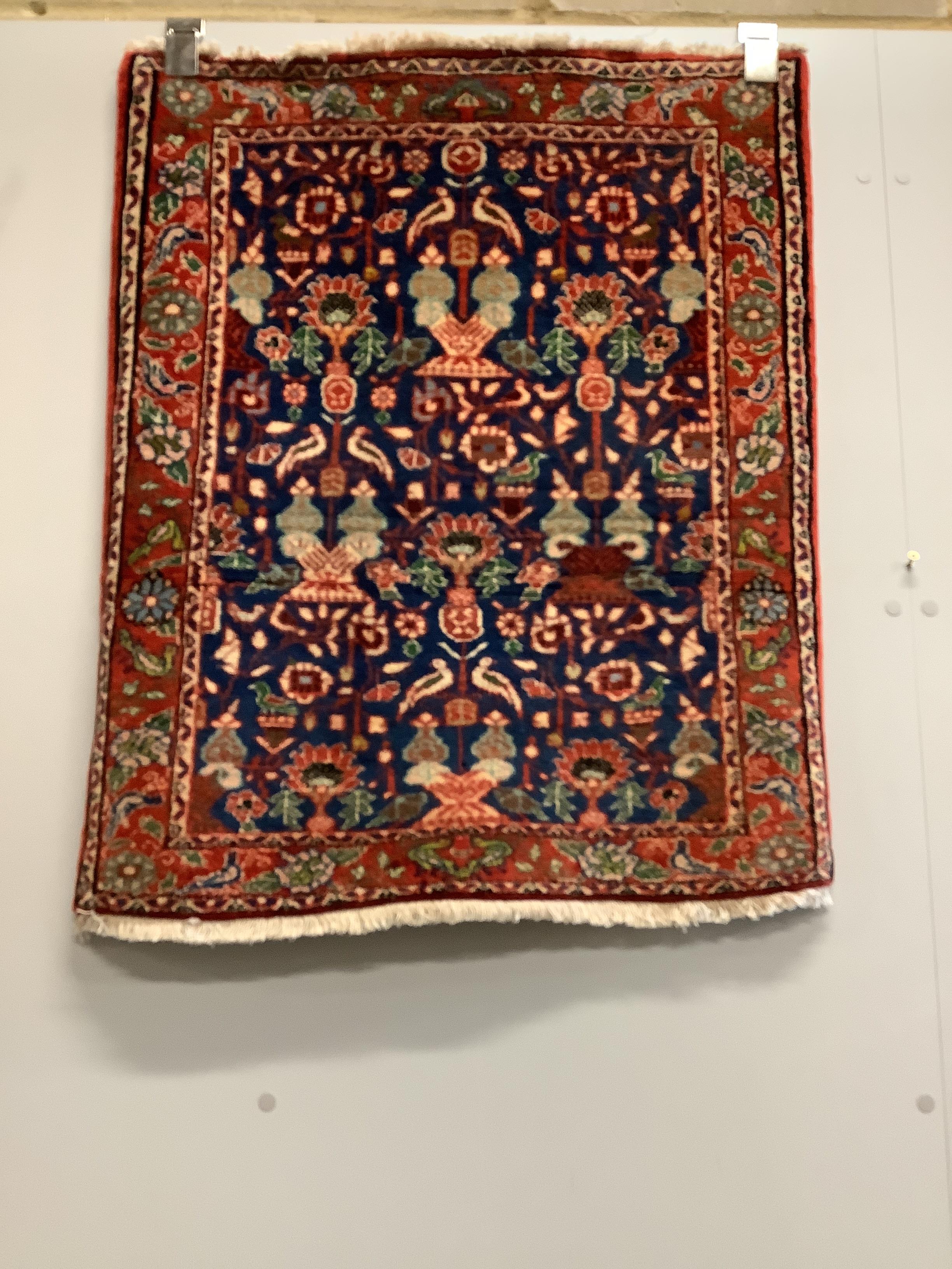 A Caucasian style red ground rug together with a North West Persian blue ground rug, larger 124 x 73cm